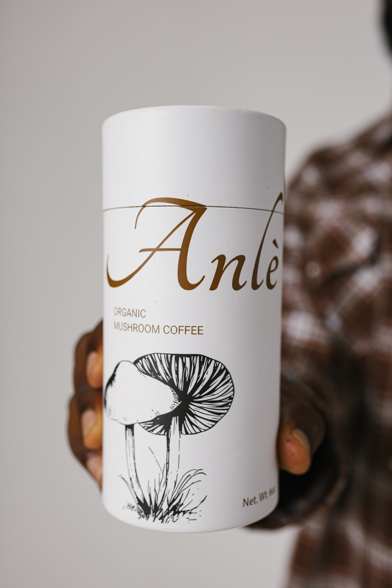 Hands holding the Anlè organic mushroom coffee tube